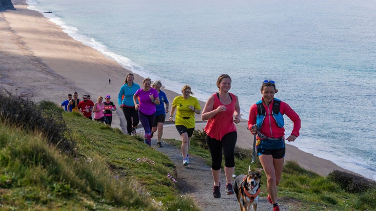 People taking part in a trail run on the Cornwall coast
